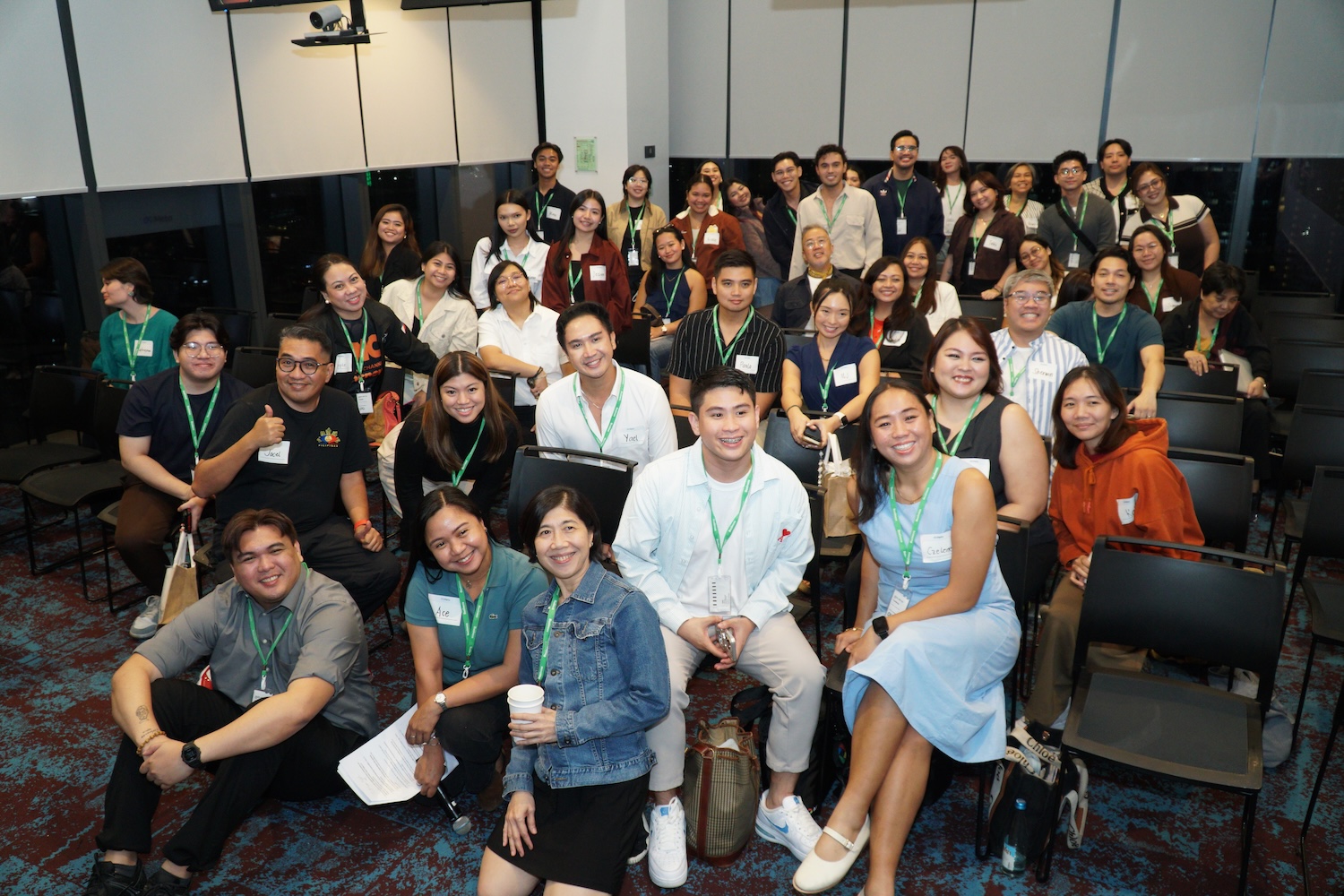 Large group event photo with green lanyards
